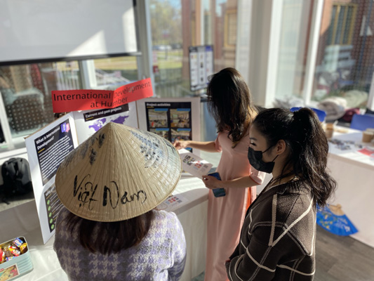 Three people at a booth