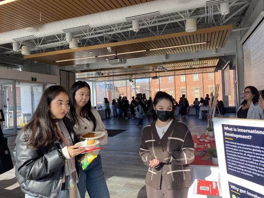 Three people at an information table
