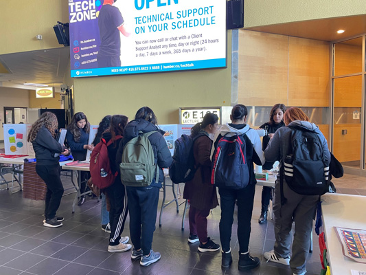 Group of students standing in front of a table