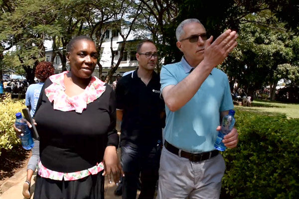 Group of people walking together pointing at something off screen