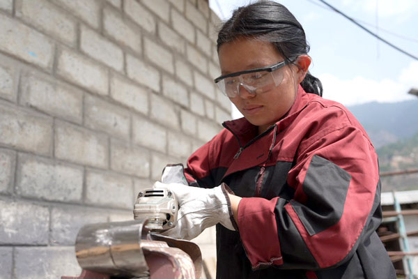 Person wearing safety glasses using tool